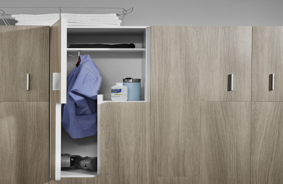 Gray oak woodgrain laminate locker with door open to show blue scrubs, hand sanitizer and water bottle