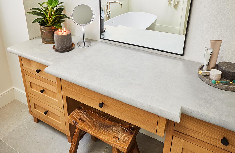 Contemporary bathroom vanity with light gray Patine Chalk Formica Laminate countertop, stool, plant and mirror